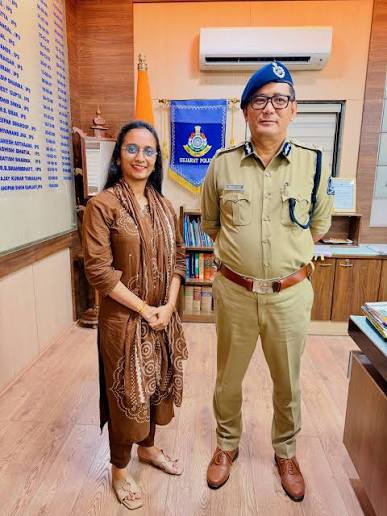 Wabang Jamir, IPS, standing in uniform in his office beside the national flag and the Gujarat Police pennant.