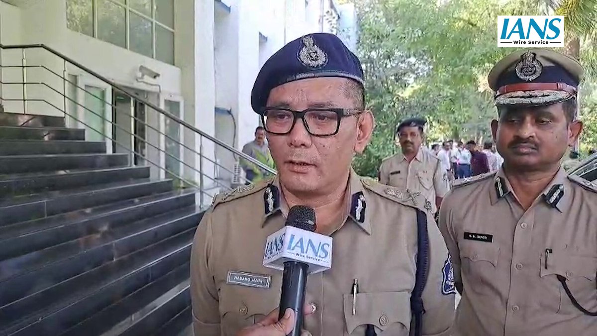 Wabang Jamir, IPS, speaking to reporters outside a Gujarat Police building alongside a senior colleague.