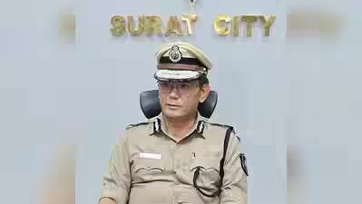 Wabang Jamir, IPS, seated before a Surat City backdrop during an official engagement.